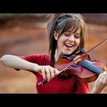 Lindsey Stirling playing violin outdoors