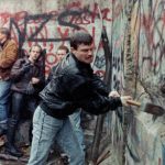 Behind the Wall: Then & Now” – change to, “East German citizens assist in breaking down the Berlin Wall with mallets