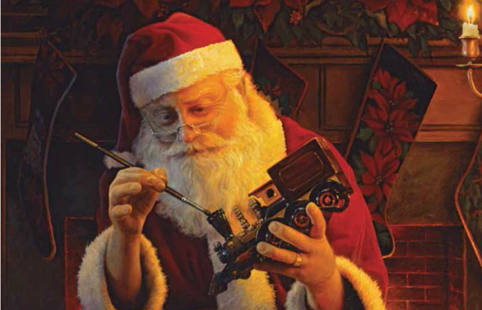 Santa Claus painting a toy train