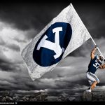 BYU football player raising flag