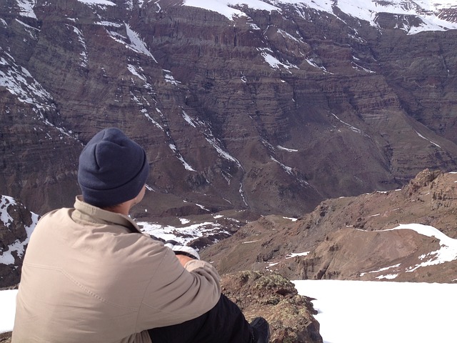 Man sitting in mountains contemplating