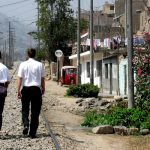 Two missionaries walking in a 3rd world street
