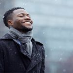man enjoying falling snow