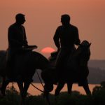 Joseph and Hyrum Smith on horseback sunset