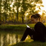 girl reading by pond mormon