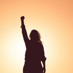 woman standing with fist in air