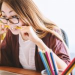 woman dealing with stress chewing on a pencil