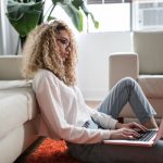 woman sitting on the floor and working from home