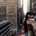 woman asleep on the side of tall building
