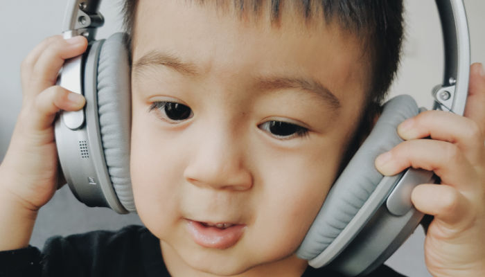young boy wearing big headphones